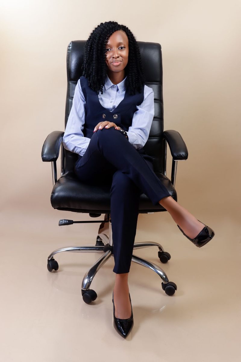 Susan Wakarindi at her desk chair in an office setting