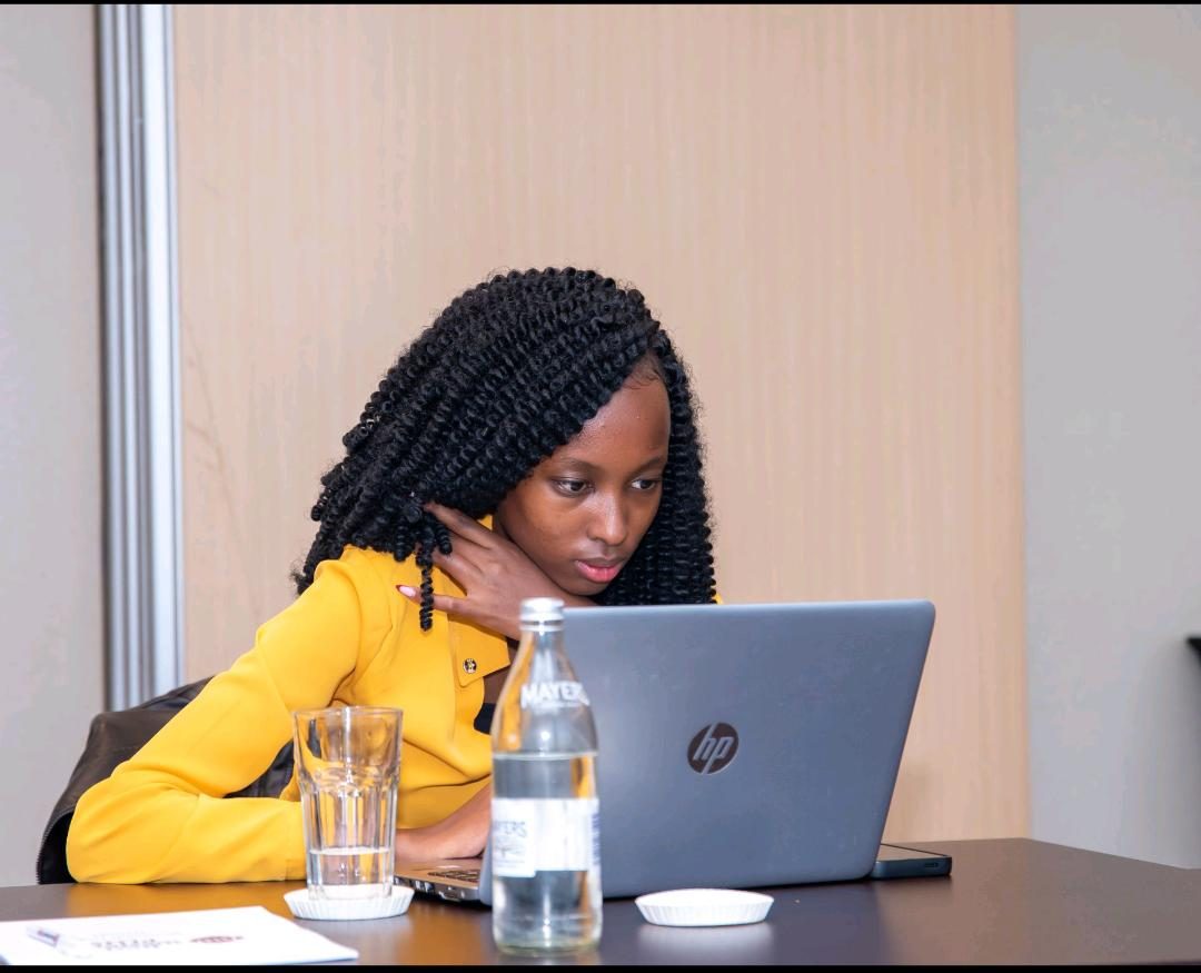 Susan Wakarindi working at a laptop